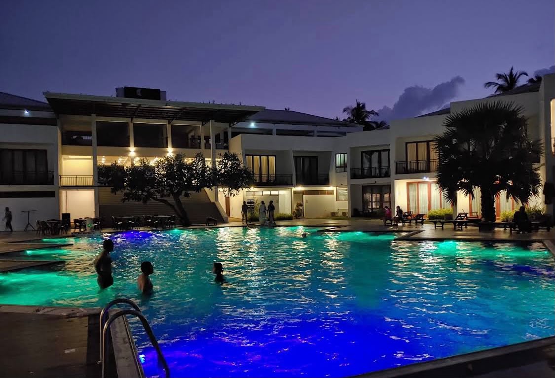 Resort swimming pool illuminated at night – kitesurfing accommodation in Kalpitiya